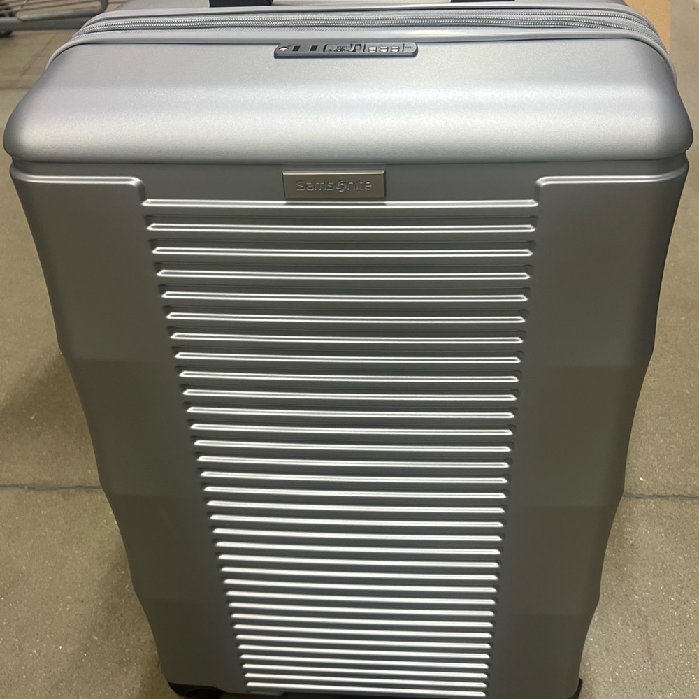 Brand New 24” Samsonite Metallic Silver Hard-Shell Spinner Luggage
